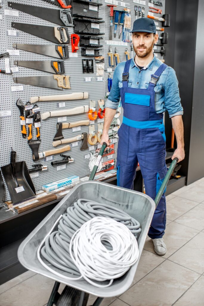 Worker in the shop with building goods